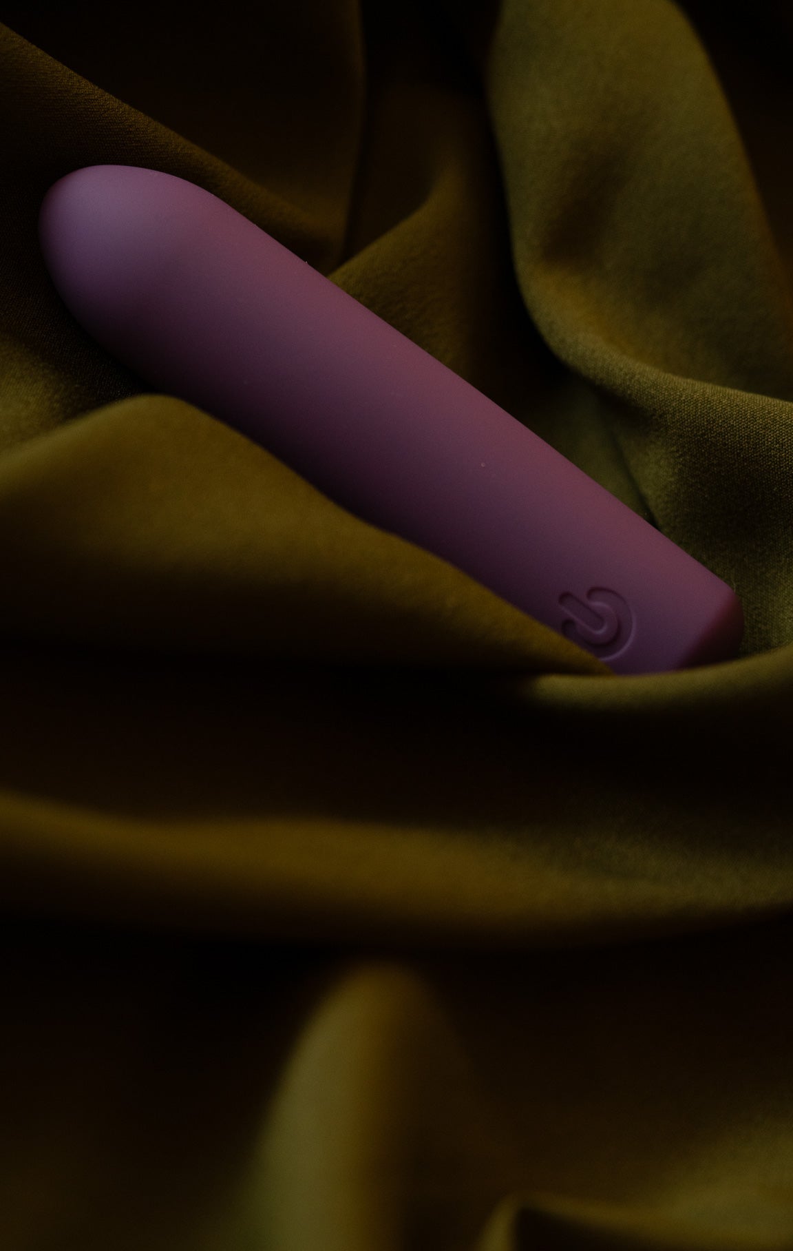 Purple Lali (named Rani) adult toy on green bedsheet with Pleasure is all yours text
