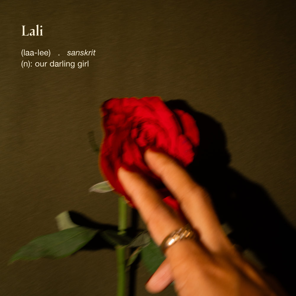Woman’s hand touching rose with Lali’s meaning and a Learn More button